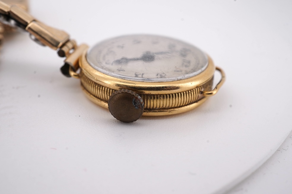 A lady's 1950's 9ct gold Tudor manual wind wrist watch, with Arabic dial, case diameter 18mm, on a damaged 9ct gold bracelet, gross weight 18.6 grams, together with a lady's 18ct gold Buren manual wind wrist watch, on a